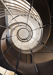 View of a spiral staircase looking up through the center