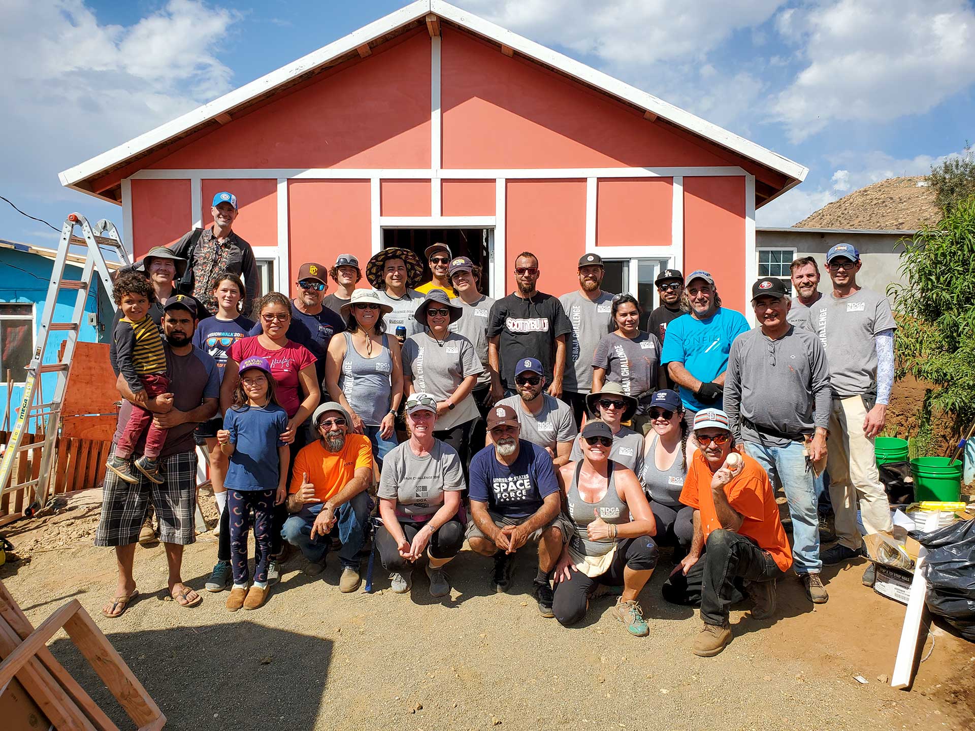 Group photo from the Baja Challenge event in 2022 including the family that the house was built for in Mexico