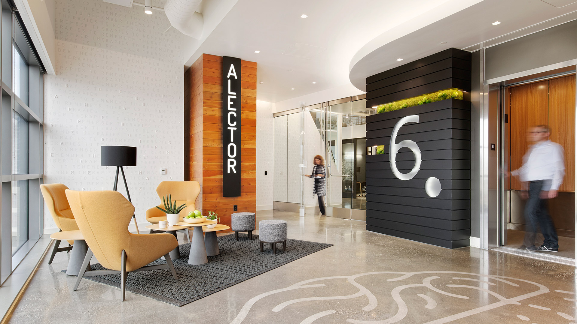 Interior at Alector life Science facility elevator, branding, seating area