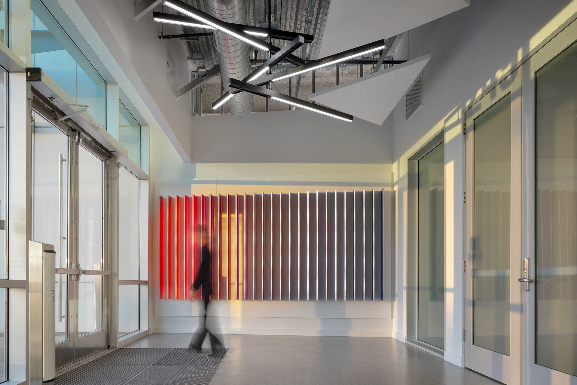 Interior at a confidential life science facility, entrance space with colorful wall lighting feature