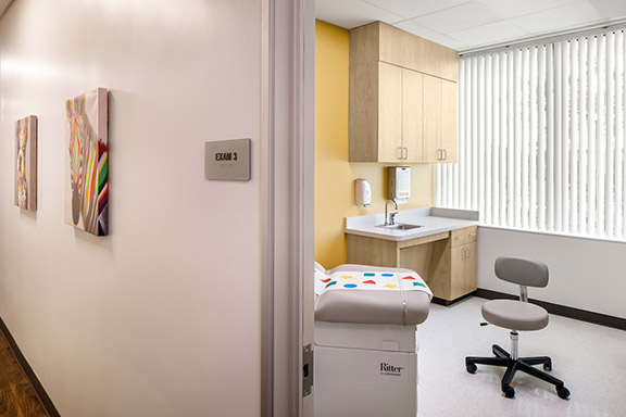 Interior of Elica Health Watt healthcare facility view from hall into exam room