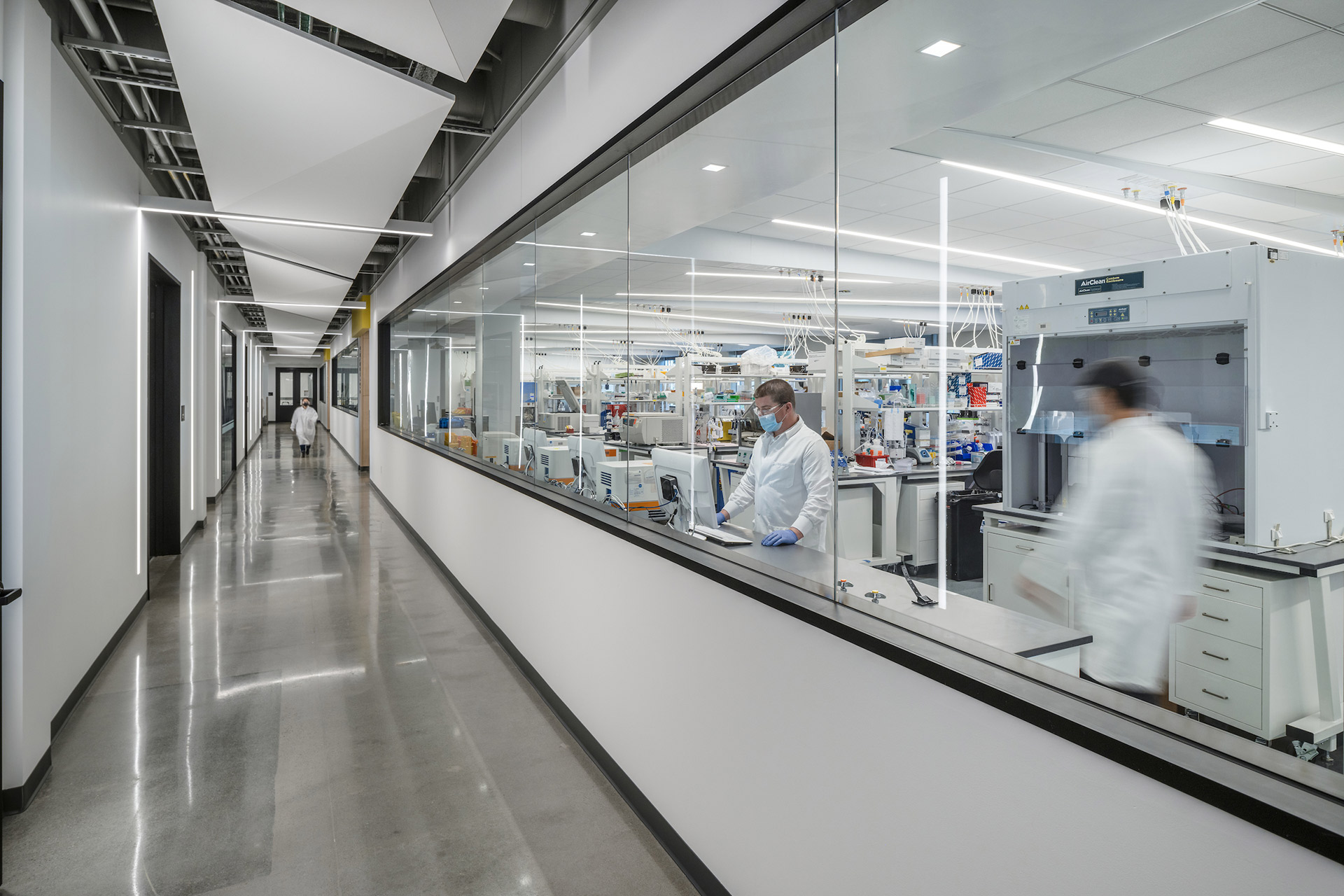 Interior at Exelixis 1701 HBP life science facility circulation with science on display views into labs and people working