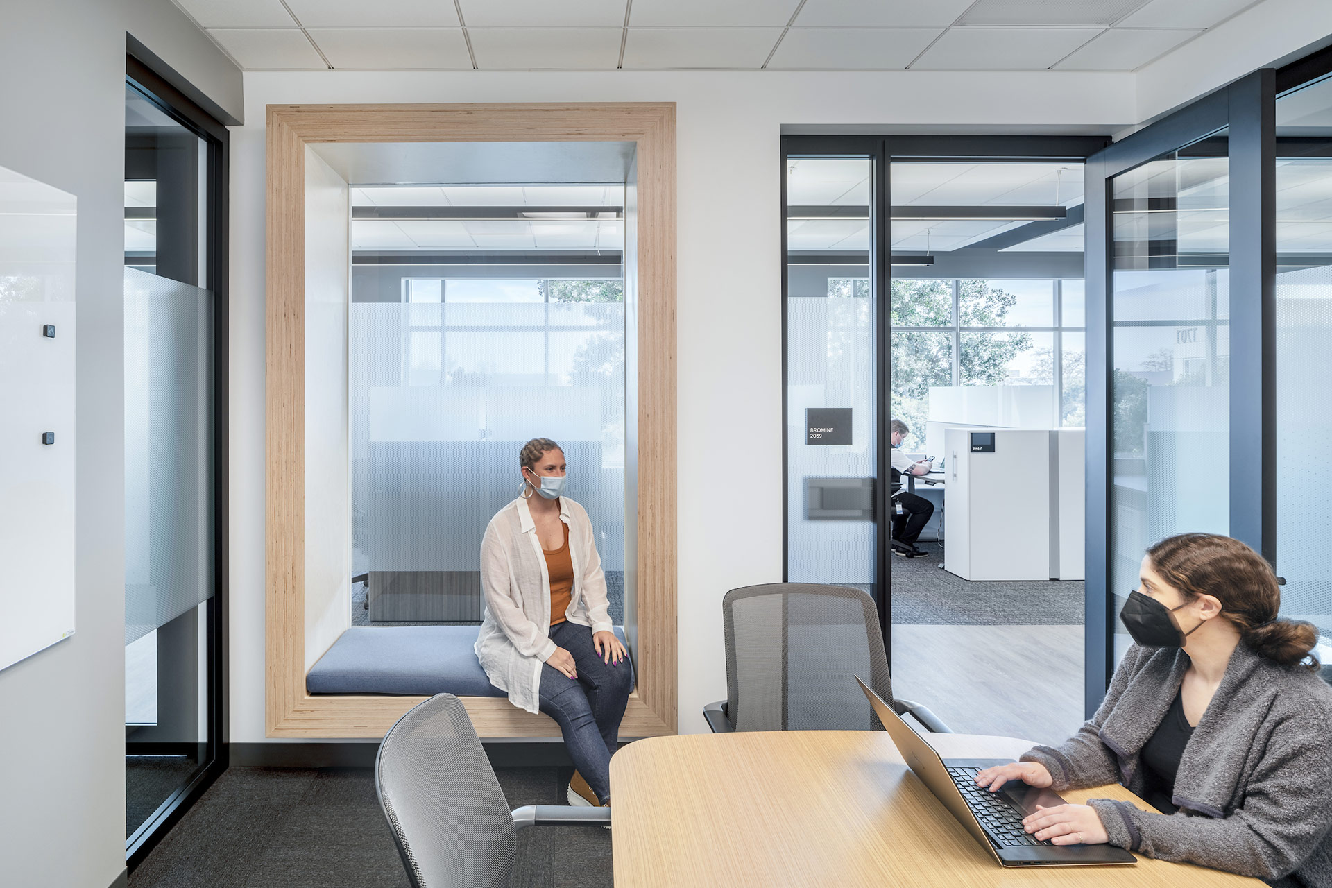 Interior at Exelixis 1701 HBP life science facility conference room with people working wearing masks