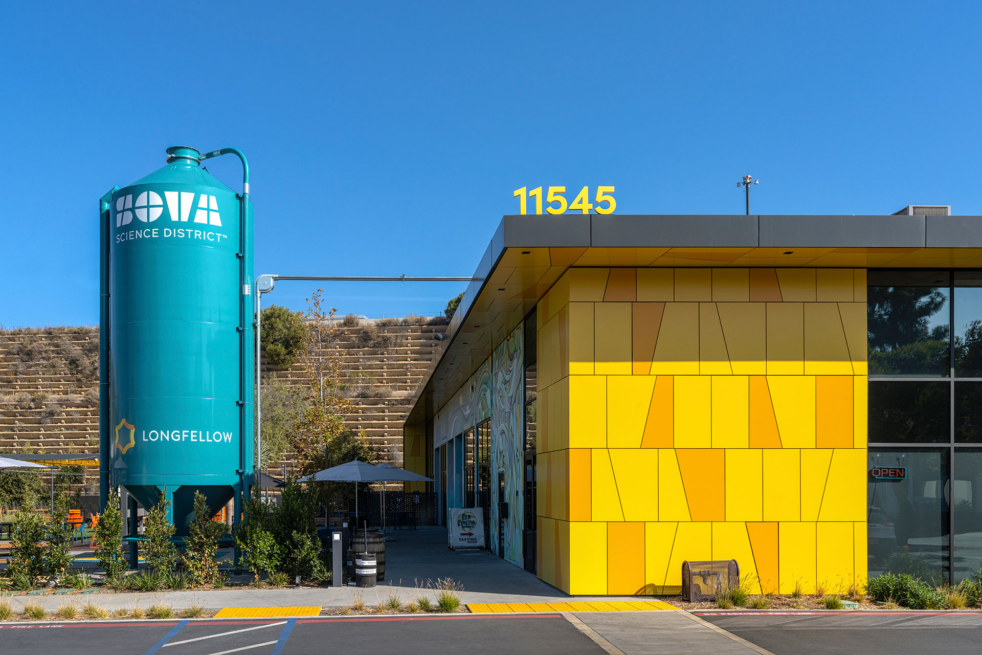 Exterior at Longfellow SOVA Science District life science facility, front view of building and outdoor amenity space