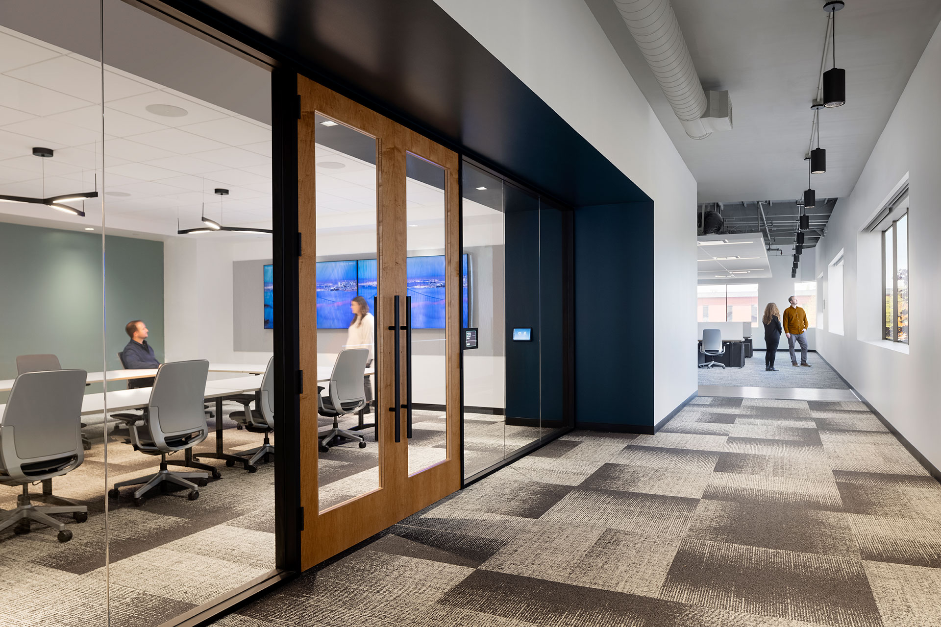 Interior at Pivot Bio life science facility, circulation with view into a large conference room and open office space in the background