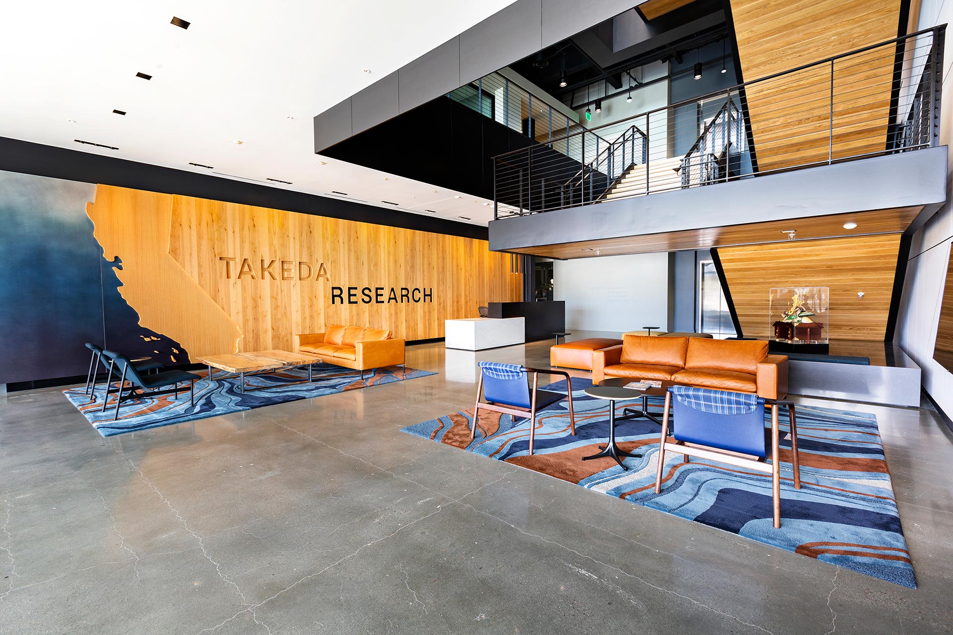 Interior at Takeda Research lobby, central stair, branding