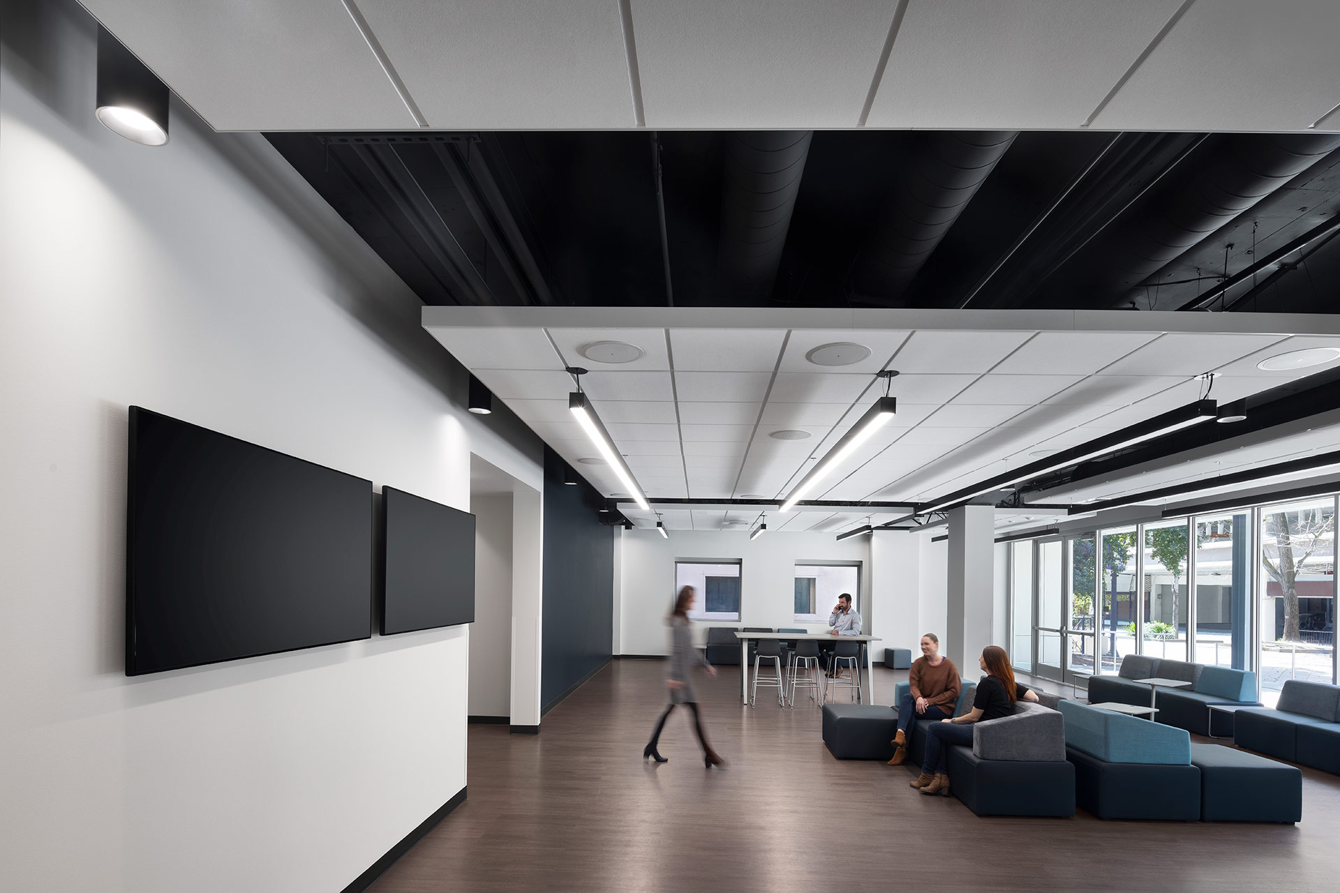 Interior at UC Center Sacramento academic facility, collaboration support space with people meeting and walking through