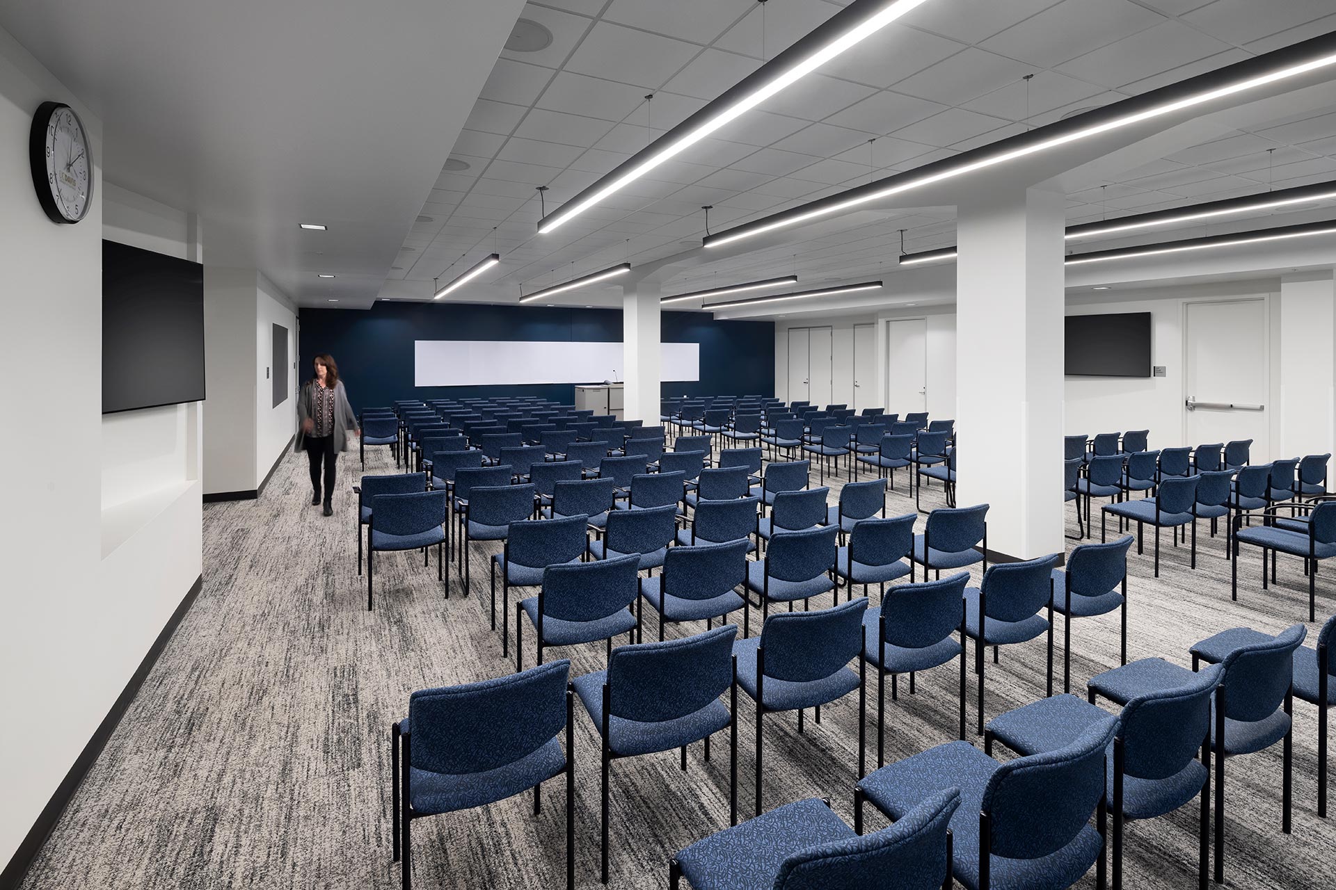 Interior at UC Center Sacramento academic facility, large conference training room with someone walking through