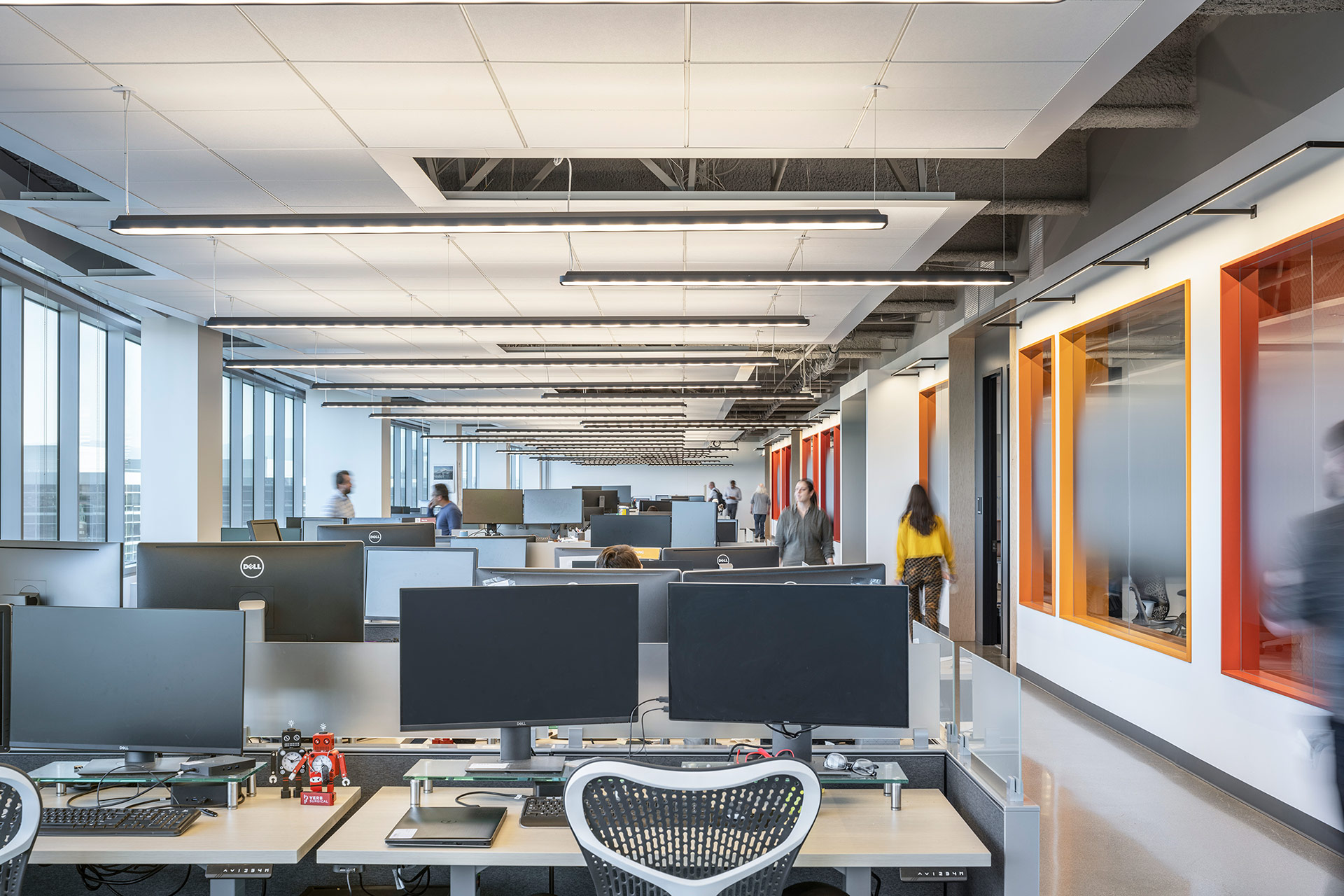 Interior at Verb Surgical HQ life science facility, open and private offices with people moving throughout