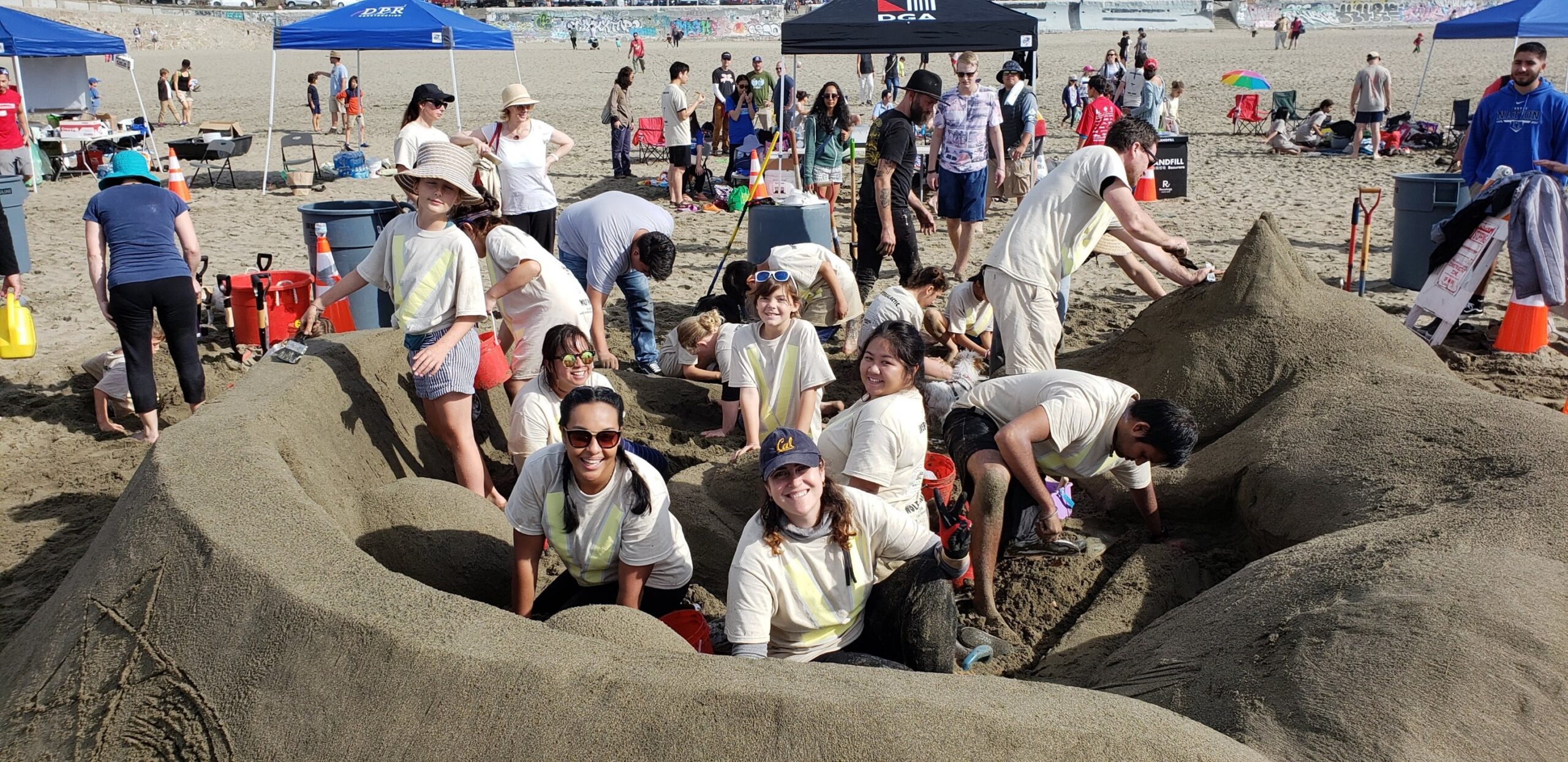DGA group with children at sandcastle charity event